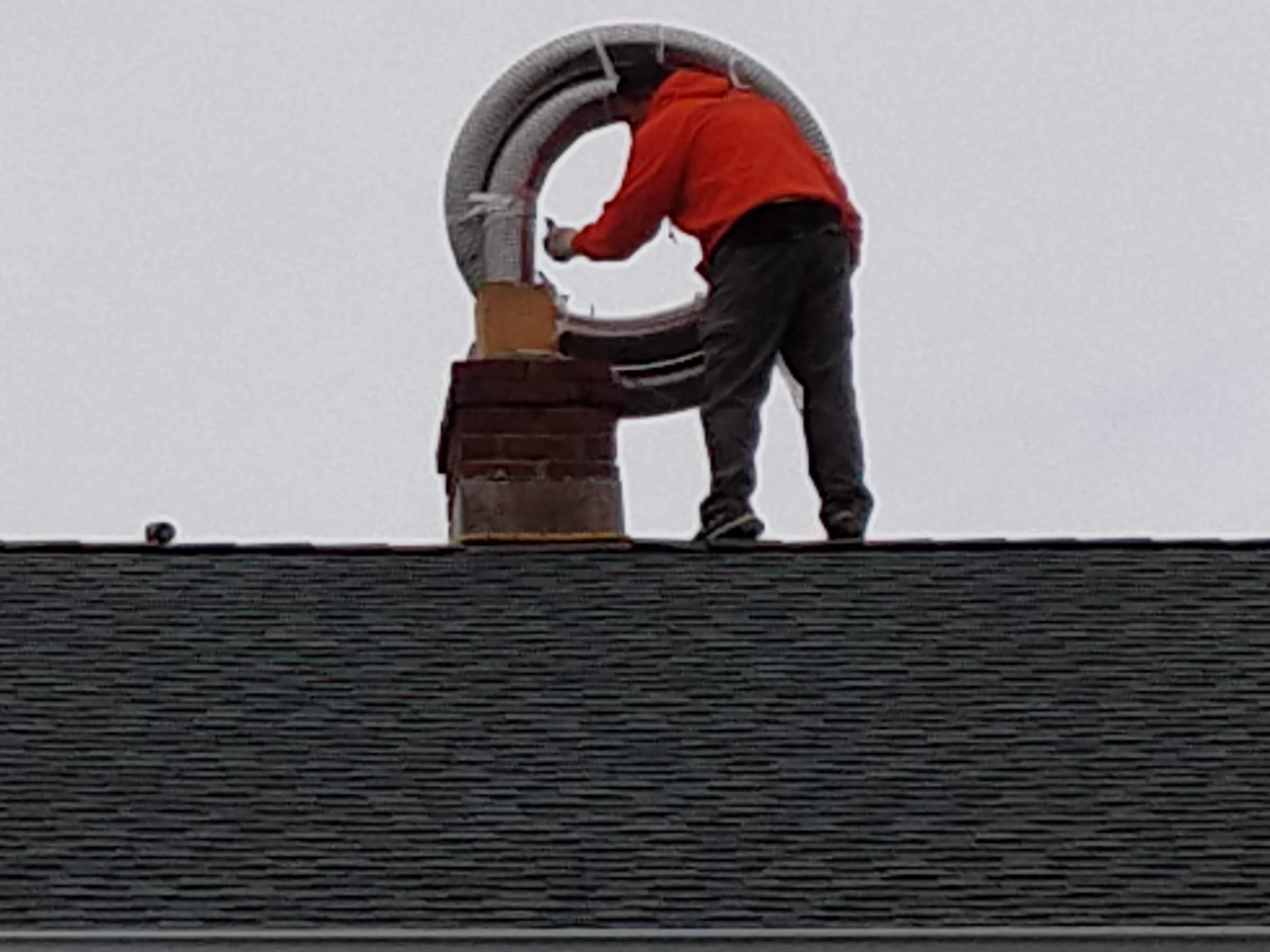 Flexible stainless chimney liner being installed in East Meadow, New York